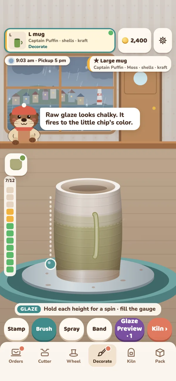 The decorate station on a rainy day: a mug spins on the wheel as moss-green glaze fills its coat gauge.