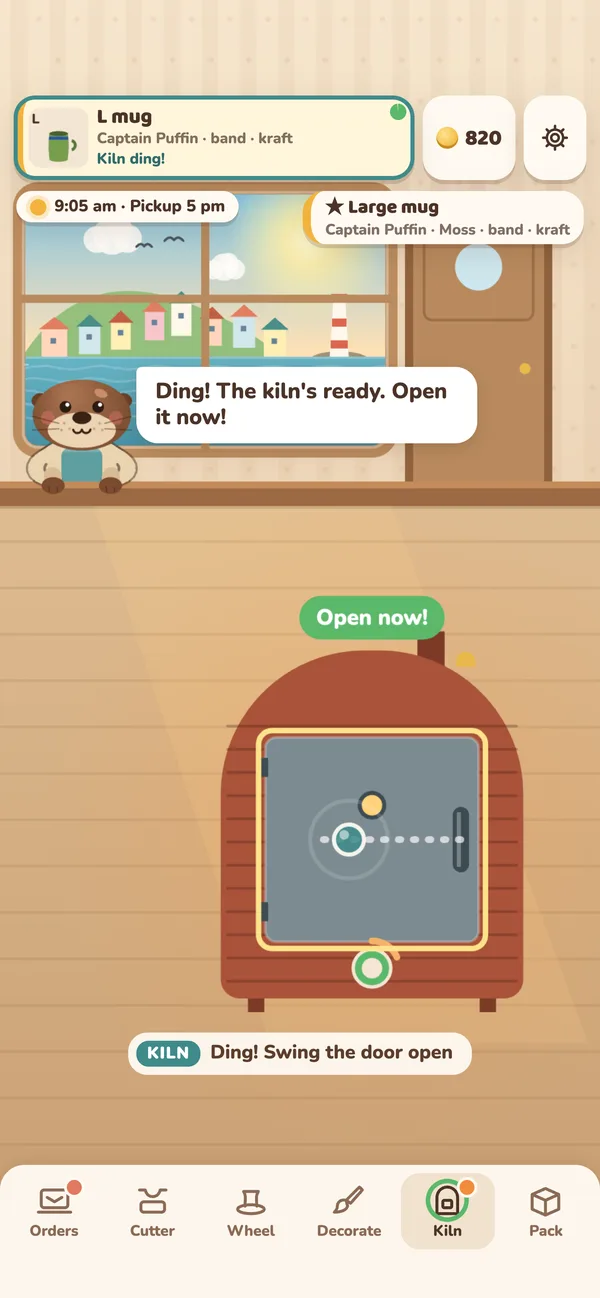 The kiln station: the little brick kiln says Open now! and Olly calls out that the kiln’s ready.