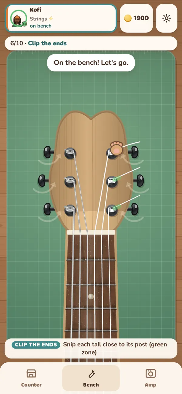 Restringing an electric guitar on the bench: new strings run up to the tuning pegs, ready to clip the ends.
